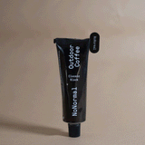A hand holding a NoNormal Tube Squeeze Key, using it to flatten an aluminum tube. — view 2