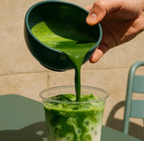 PerfectTed ceremonial grade matcha being poured into an iced matcha latte in a clear glass cup