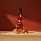 Hazelnut Syrup bottle on a stone display with hazelnuts, showcasing natural sweetness and rich flavor profile.