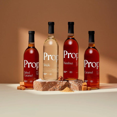 Vanilla Syrup and other flavored syrups displayed on a neutral background, showcasing quality natural ingredients.