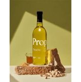 Pistachio Syrup bottle on natural stone, featuring organic ingredients and gluten-free label.