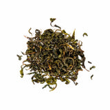 Dried leaves of Single Cultivar Organic Koshun Japanese Oolong tea on a white background.