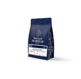 The Coffee Lab Decaf coffee beans in dark blue packaging, featuring Colombian decaffeinated specialty coffee with chocolate notes, balanced body, and lively acidity.