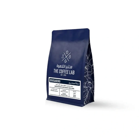 The Coffee Lab Divisadero specialty coffee beans in premium navy blue packaging with tasting notes of roasted hazelnut, wafer biscuit, toffee, and raisin.