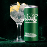 A green can of Frío Lumii Zero calories sparkling drink with lemon scent, shown next to a garnished cocktail glass on a dark green textured background. White text at the top reads 'Emirati Brand Made in the UAE' with a small UAE flag.