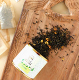 JPremium OH CHA Jasmine loose leaf green tea with dried jasmine blossoms in decorative metal tea canister.