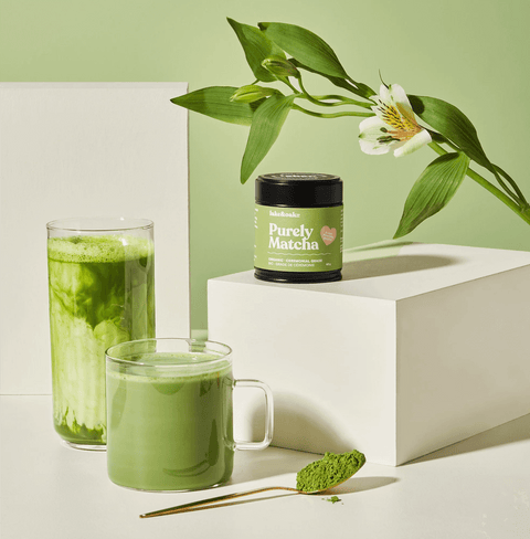 Purely Matcha ceremonial grade matcha powder displayed with drinks showcasing vibrant green colors.