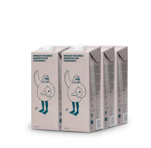 Three cartons of Minor Figures Barista Oat (Organic) milk, arranged in a row on a clean white background.