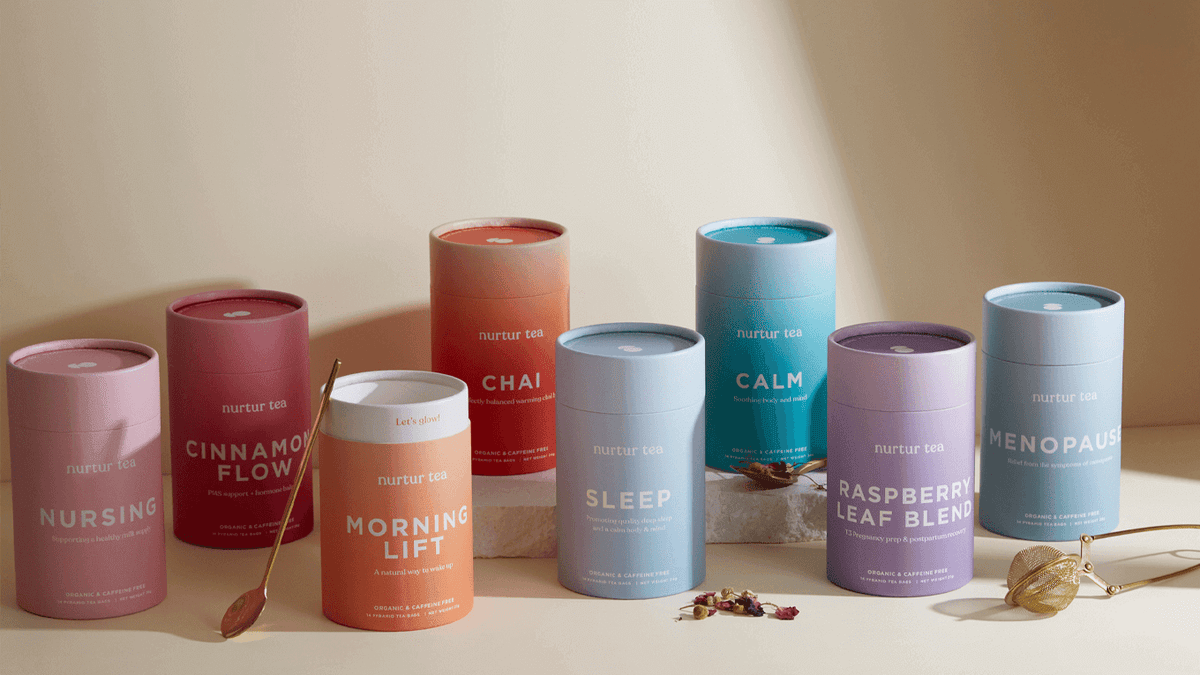 An assortment of herbal tea containers including Nursing, Cinnamon Flow, and Menopause blends.