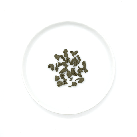 Oolong tea from Fujian, China, hand-rolled and infused with ginseng powder, offering a rich, lingering sweetness in the cup.