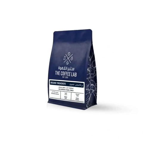The Coffee Lab Organic Yirgacheffe coffee beans in premium dark blue packaging, featuring Ethiopian specialty coffee with milk chocolate, prune, and pomelo flavor notes.