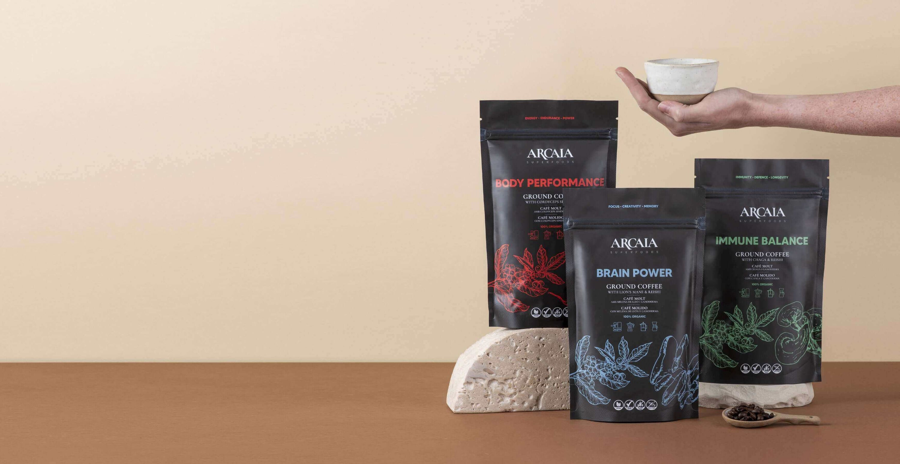 ARCIA supplement pouches for body performance, brain power, and immune balance with a hand holding a serving cup