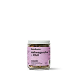 Ashwagandha + Chill Superfood Tea in a glass jar with a pink label, promoting relaxation and well-being.