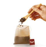 Biodegradable Tea Filters being filled with loose-leaf tea for eco-friendly brewing.