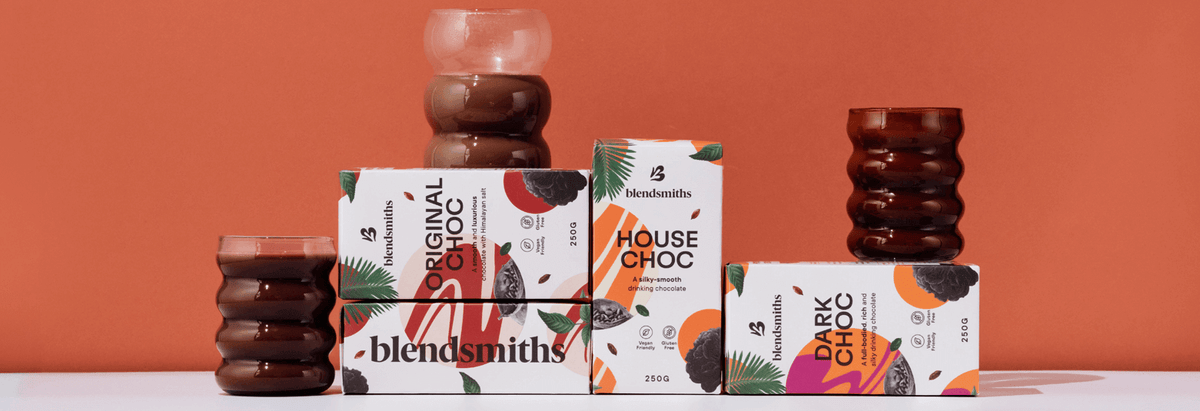 Blendsmiths artisan drinking chocolate collection, featuring Original Choc, House Choc, and Dark Choc blends. Premium, dairy-free, and ethically sourced hot chocolate drinks displayed with elegant glassware against a warm-toned background.