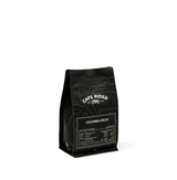 Cafe Rider Roastery's Colombia Decaf coffee with peach, maple syrup, and chocolate notes, decaffeinated using sugarcane E.A. method.