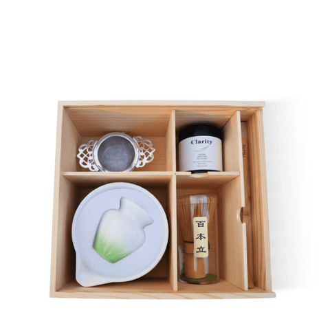 Matcha Starter Kit including a matcha bowl, bamboo whisk, sieve, and Clarity matcha, elegantly arranged in a wooden box.