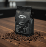 Ethiopia Buku Sayisa coffee bag surrounded by coffee beans on wooden surface, highlighting premium organic Ethiopian heirloom coffee.