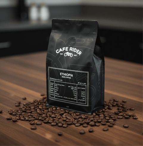 Ethiopia Buku Sayisa coffee bag surrounded by coffee beans on wooden surface, highlighting premium organic Ethiopian heirloom coffee.