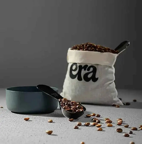 Ethiopia Guji Hambela Heirloom coffee beans in a measuring spoon and bag, showcasing specialty coffee quality.