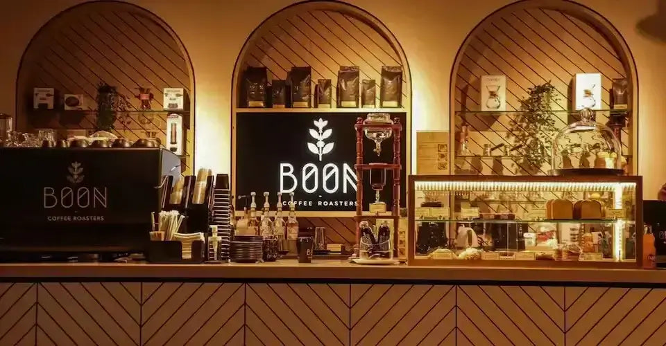 Interior of Boon Coffee Roasters showcasing a stylish coffee bar with decorative elements and branded merchandise.