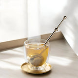 Elegant gold modern fine mesh tea infuser for precise and flavorful loose-leaf tea brewing.