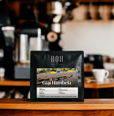 Guji Hambela Ethiopian coffee bag on a wooden counter, showcasing smallholder farming purity and balance in aroma.