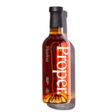 Hazelnut Syrup bottle featuring Proper! branding, showcasing natural syrup for beverages and desserts.