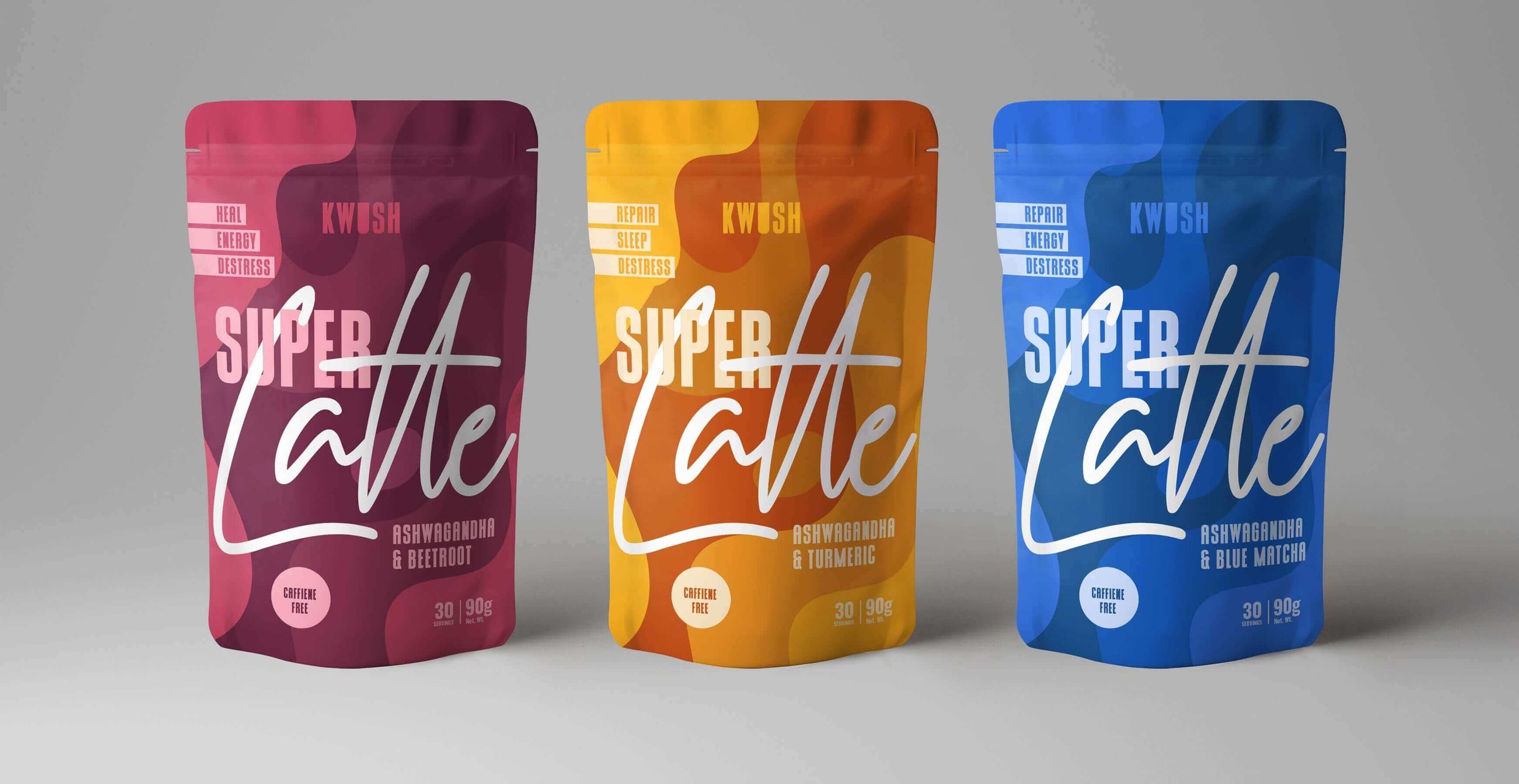 Three colorful Super Latte supplement pouches in pink, orange, and blue packaging on a gray background