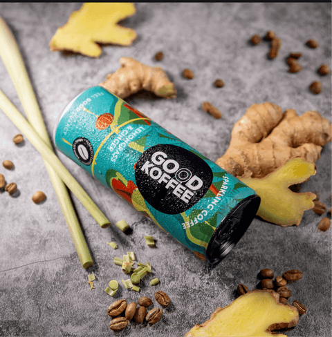 Lemongrass & Ginger Sparkling Coffee - Vietnam can surrounded by fresh lemongrass, ginger, and coffee beans on a textured surface.