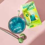 Matcha Lemonade beverage and packaging with blue ice drink on a pink background.