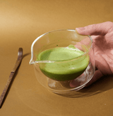 Hand-blown glass mug for whisking, sipping, and serving. Sleek, versatile, and comfortable design for daily use.