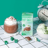 Mint Chocolate hot cocoa with whipped cream and mint ice cream, featuring superfun! packaging and a playful vibe.