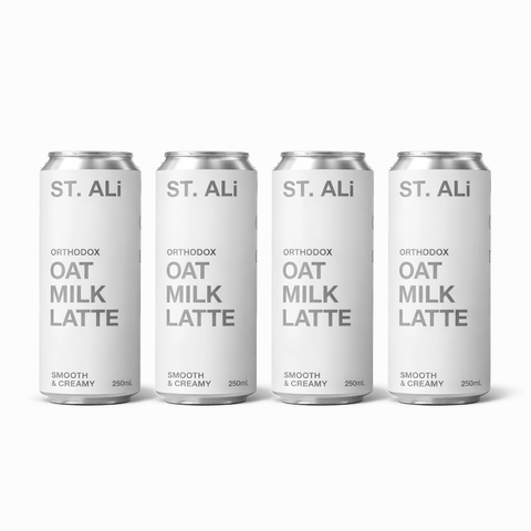 Four cans of Orthodox Oat Milk Latte by ST. ALi, featuring a smooth and creamy design.