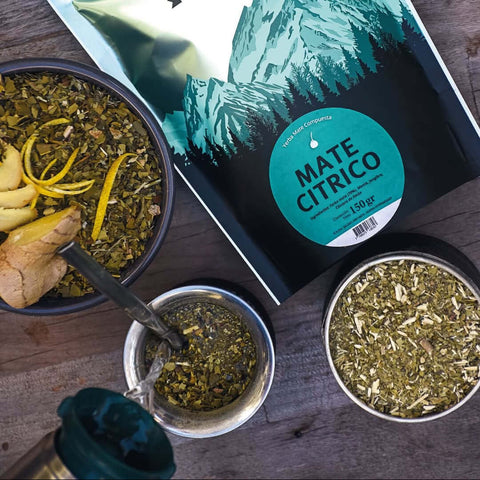 Patagonia Mate Citrico packaging with two metal bowls of mate leaves on a wooden surface