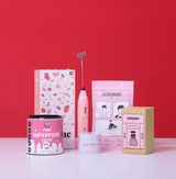 The Pink Gift Set For Her featuring matcha tea and superfood latte products on a vibrant red background.