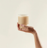Turkey Tail Mushroom Powder in a glass held by hand for gut health and microbiome support