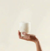 Tremella Mushroom Powder in a ribbed jar held by hand, hydrating mushroom supplement for dewy skin