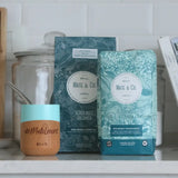 Pure Leaf Organic Yerba Mate packaging beside a traditional mate cup, showcasing organic yerba mate leaves.