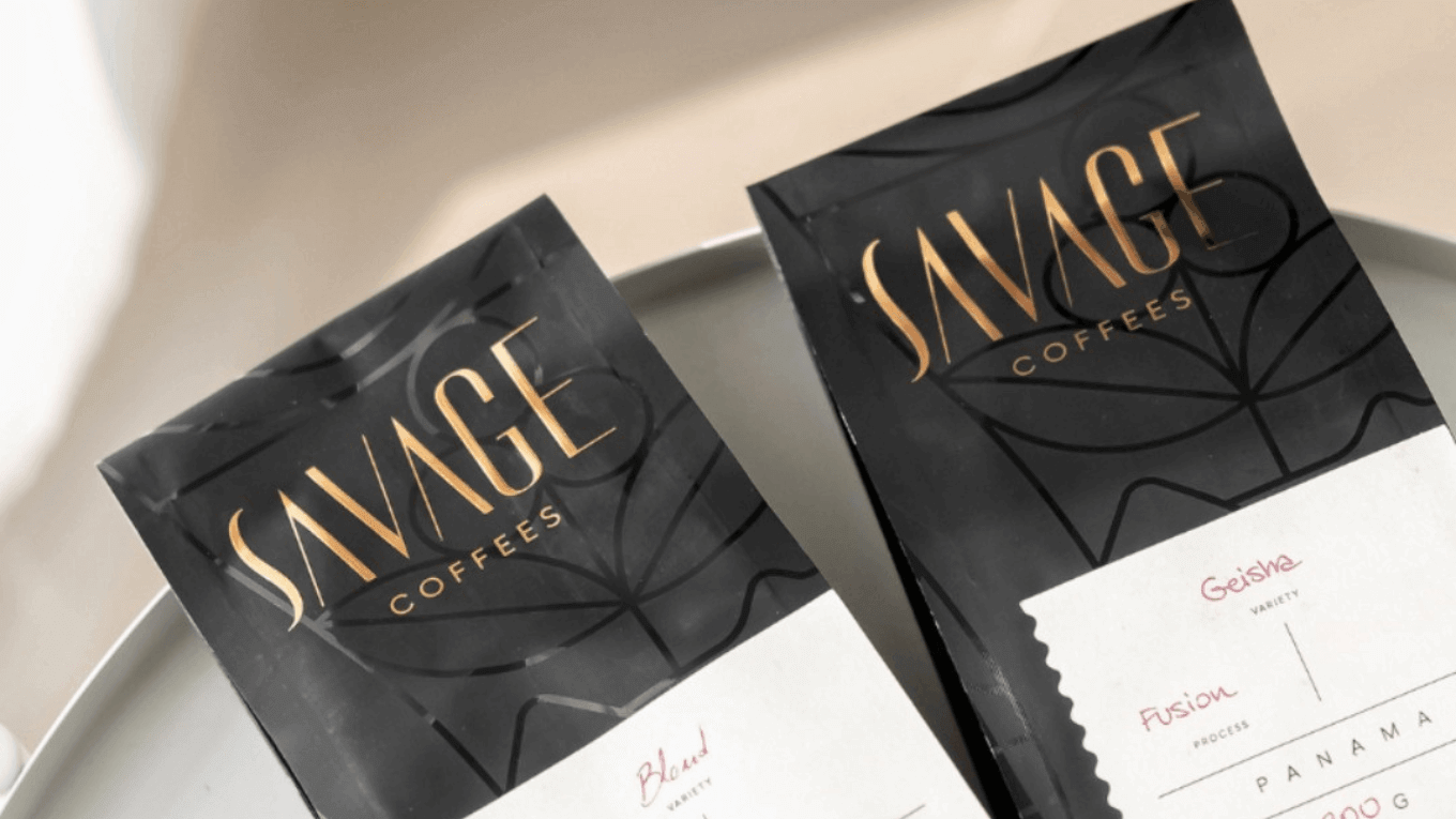 Savage Coffees packaging in elegant black with gold lettering showcasing unique blends.