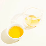 Single Cultivar Organic Koshun Japanese Oolong in a cup and teapot with bright yellow color.