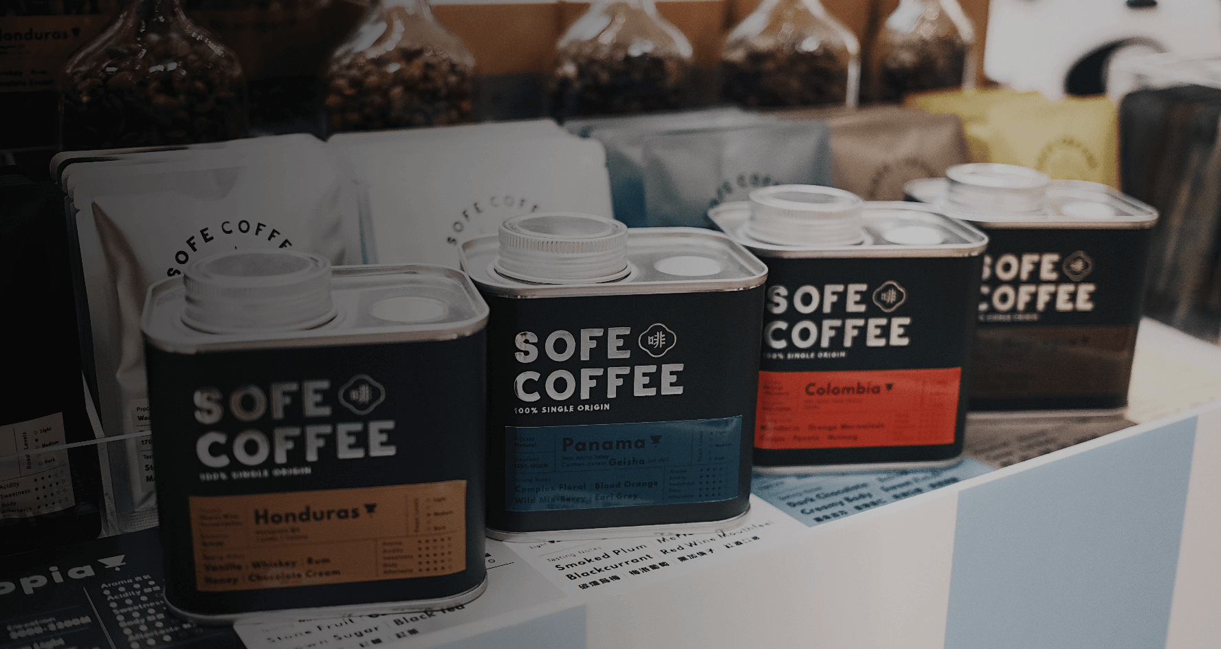 Cans of SoFe Coffee featuring Honduras, Panama, and Colombia blends on display in a coffee shop.
