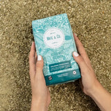 Traditional Yerba Mate package held in hands, featuring natural design and organic certification.